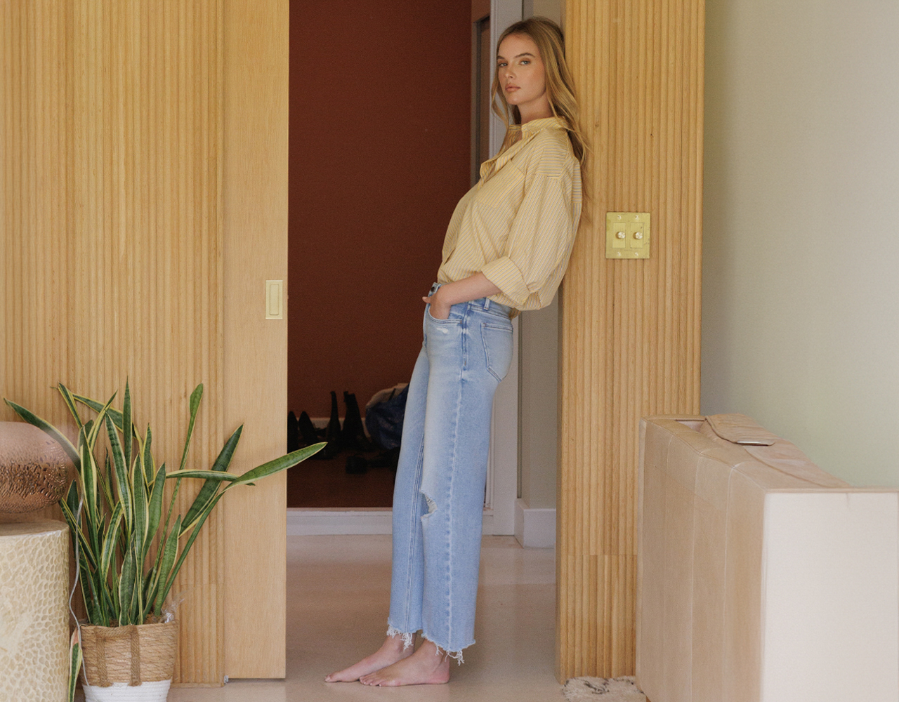 Model in High Rise Distressed Crop Slim Wide Jeans and striped shirt, linking to Flying Monkey new arrivals collection.